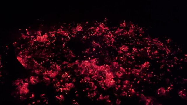 A mesmerizing abstract background image, created by glowing red and orange embers glowing in the darkness, evoking a sense of warmth and energy.