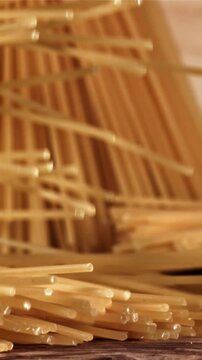 Spaghetti falling on a wooden table. Filmed on a high-speed camera at 1000 fps. High quality FullHD footage