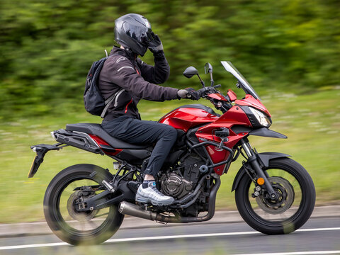 Milton Keynes,Bucks,UK - May 21st 2026:   2016 red Yamaha Tracer 700 motorcycle driving on a British road