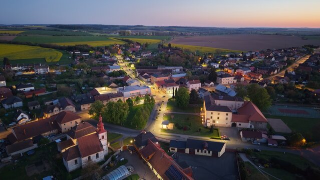 Illuminated Renaissance Suchdol Castle with decorative sgraffito facade aerial panorama at dusk