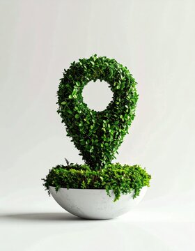 Lush green plant shaped like a location pin in a concrete pot