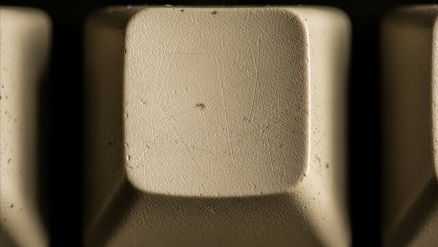 Technology - Extreme Macro Close Up of Worn Blank Keycap on Vintage Beige Keyboard with Scratches and Dust