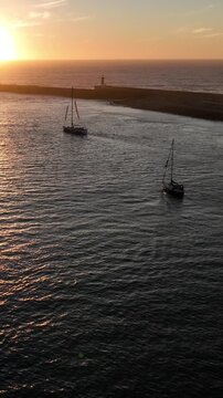 Aerial Cinematic View of Sailing Vessels at Sunset in Foz do Douro Porto Portugal Coast
