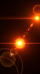 Fototapeta premium Vibrant orange and yellow lens flares creating an abstract light effect on a dark background.