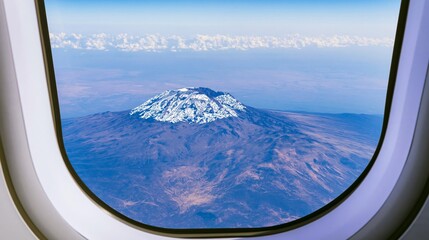 Fototapeta premium Majestic snow-capped Kilimanjaro mountain peak seen from airplane window