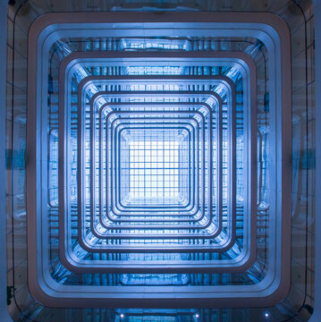 Interior multi-floor dome space viewed from a low-angle upward perspective.