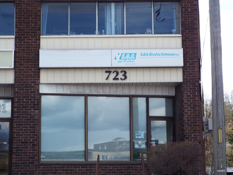 Gatineau, Quebec, Canada &ndash; April 21, 2026: A storefront for "S.O.S. &Eacute;tudes Outaouais inc." features a horizontal sign above large reflective windows at 723 Boulevard Saint-Joseph.
