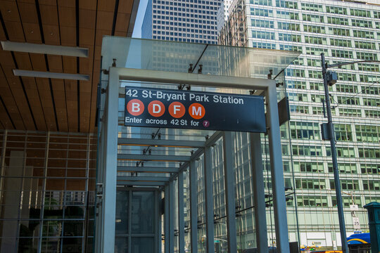 New York, NY - US - May 16, 2026 42nd St-Bryant Park subway station entrance in Midtown Manhattan, New York City. The sign indicates access to B, D, F, and M trains, with a 7 train connection nearby.