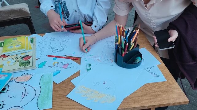 Close up of students drawing on paper during a scientific project, fine motor skills research, classroom education. pediatric development, creative therapy, educational study.