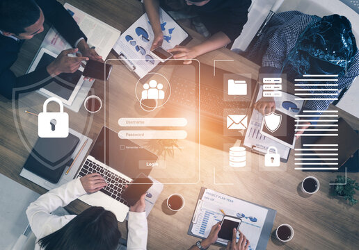 A high-angle view of a business meeting focused on cybersecurity solutions, showcasing technology use for collaboration and data protection in a modern workspace. Cyphers
