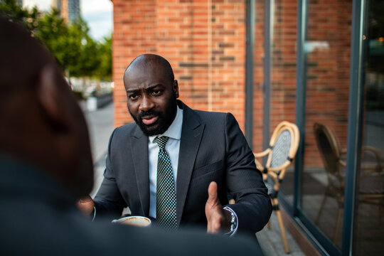 Businessman negotiating over coffee at outdoor cafe
