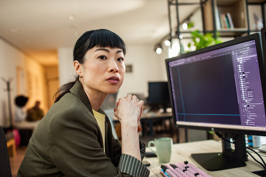 Focused designer editing on computer in modern office
