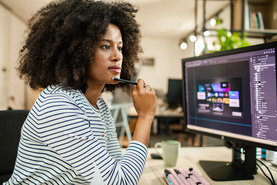 Woman graphic designer working on computer at modern office
