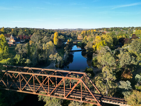 Historic Yass Railway Bridge spans a scenic river in autumn