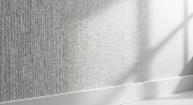 Light grey textured wallpaper with subtle abstract light patterns and a white baseboard in an interior setting.
