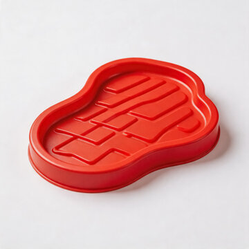 This red silicone baking mold features a steak shape with grill pattern interior, designed for making themed baked goods in home kitchen.