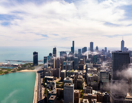 Aerial Drone View of Chicago Downtown Skyline with Low Clouds and Fog Over Skyscrapers with Lake Michigan and North Avenue Beach on a Cloudy Day&rdquo;