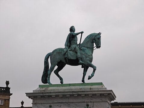 Copenhagen,Denmark-Nov.24th 2025: low-angle shot of the bronze equestrian statue of King Frederick V at Amalienborg Palace Square under an overcast sky in Copenhagen, Denmark