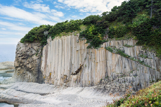 Cape Stolbchaty, Kunashir Island. Famous columnar basalt formations. Summer landscape.