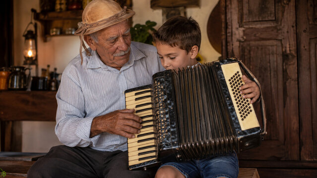 Grandfather Teaching Grandson to Play Accordion, Sharing Music and Family Tradition