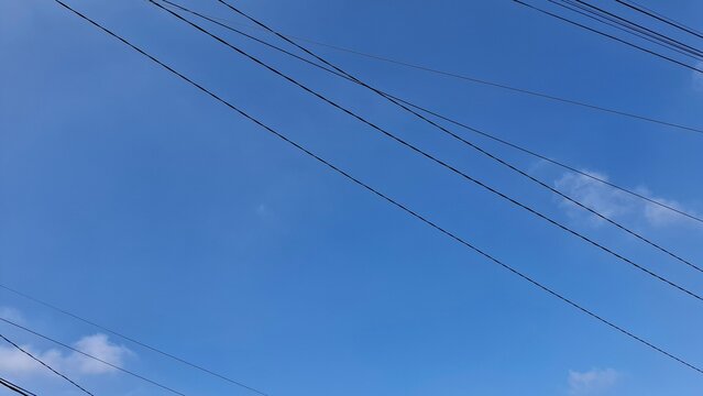 Blue Sky with Multiple Power Lines Overhead Urban Landscape