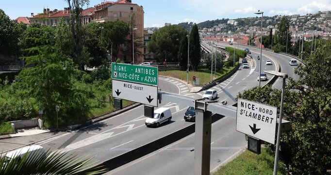 Nice France May 5, 2026 highway intersection features busy traffic flow under green directional road signs. Large signage indicates routes toward Nice Cote d Azur airport Antibes and Digne while white