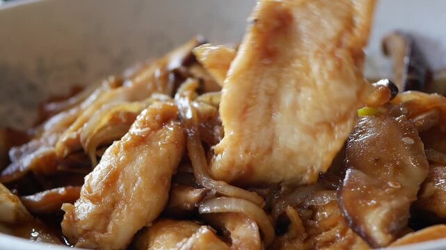 Chicken stir fry with vegetables and sauce in bowl