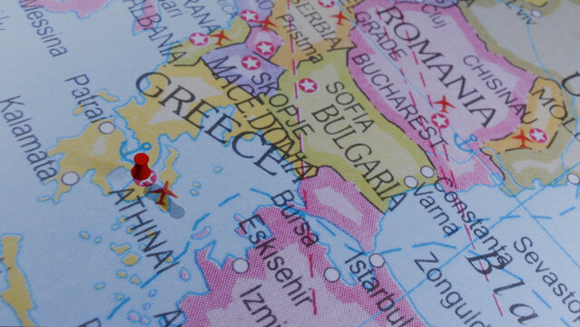 Detailed map of Greece with Athens marked by a red pin, highlighting Balkan countries and the Aegean Sea.