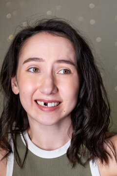 Mature Caucasian woman expressing emotions after losing a front tooth during dental procedures at home