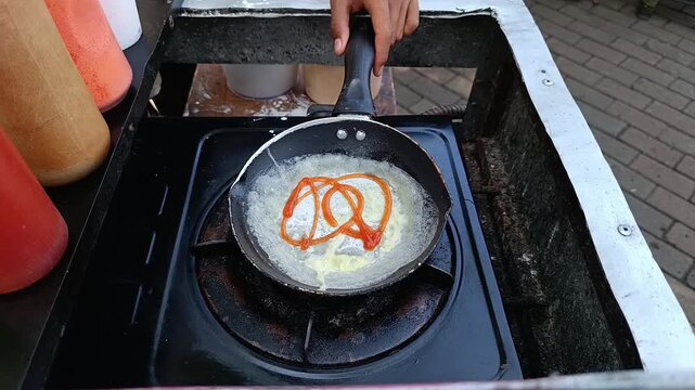 Frying Pan with Melted Butter on Portable Stove in Outdoor Kitchen