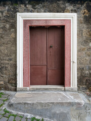 Fototapeta premium An ancient wooden door in the historic part of the city. The architecture is Ottoman-style.