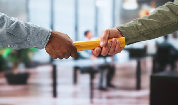 Two Businessmen Pass The Baton Quickly Showing Trust