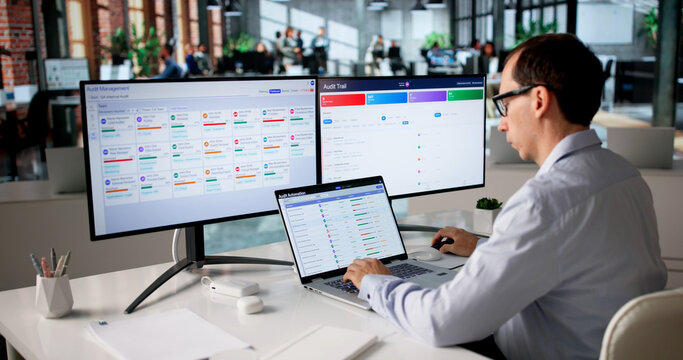 Man Uses Automated Software System On Laptop