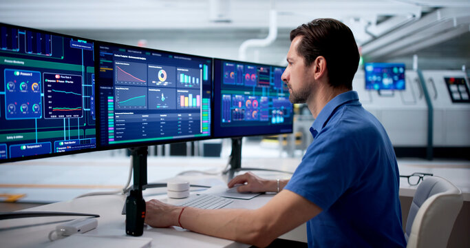 Experienced Engineer Watches SCADA System Controlling Factory Process