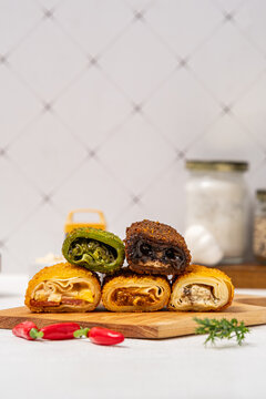risol with five variants, namely, matcha cheese, chocolate cheese, original mayo, beef brulee, and creamy chicken mushroom, with abundant filling and crispy fried risol skin, served on a wooden cuttin