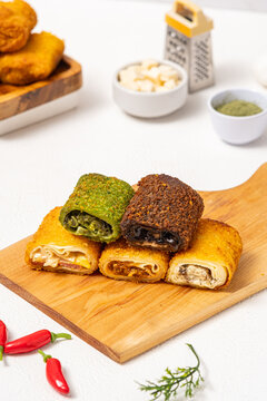 risol with five variants, namely, matcha cheese, chocolate cheese, original mayo, beef brulee, and creamy chicken mushroom, with abundant filling and crispy fried risol skin, served on a wooden cuttin
