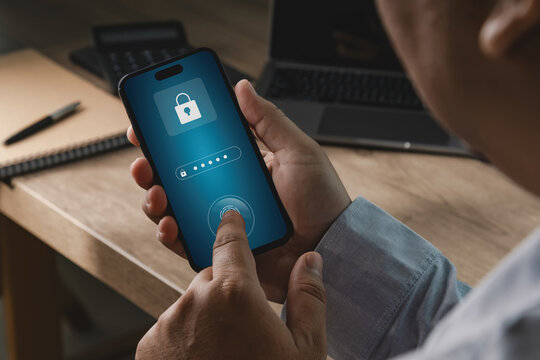 Person using smartphone with password and fingerprint authentication interface in office workspace, suitable for banking security, payment protection, account recovery, and digital privacy concepts.