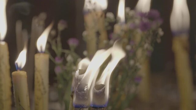 Lighting candles to worship Buddha statues in temples is a traditional Asian practice.