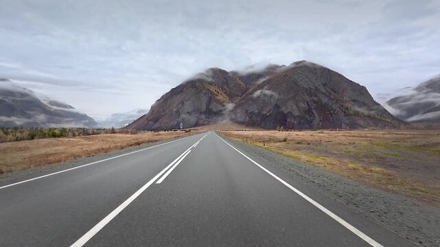 Road trip along Chuysky Trakt through misty Altai mountains and autumn valleys during late autumn