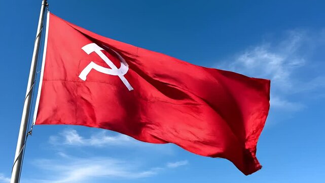 Red Flag with Hammer and Sickle Symbol Waving in Blue Sky.