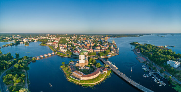 Vyborg Castle and Saint Olaf Tower stand proudly on an island, overlooking the city and Vyborg Bay in Russia during a bright sunny day