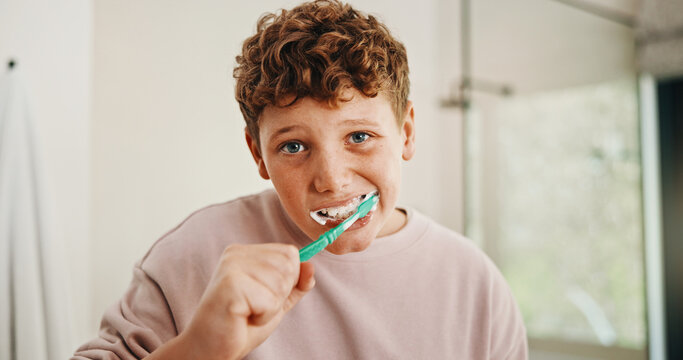 Toothbrush, dental health and portrait of kid in bathroom for development, growth or hygiene in home. Toothpaste, wellness and boy child brushing teeth in morning for plaque removal and oral care.