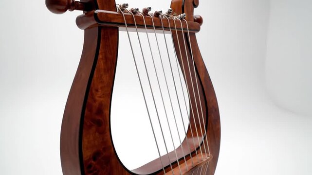 Ancient Greek lyre musical instrument with polished wooden body and seven strings isolated on a white background, featuring detailed wood grain and classical antique design.