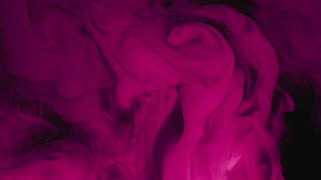 Magenta ink swirling in water motion flow.