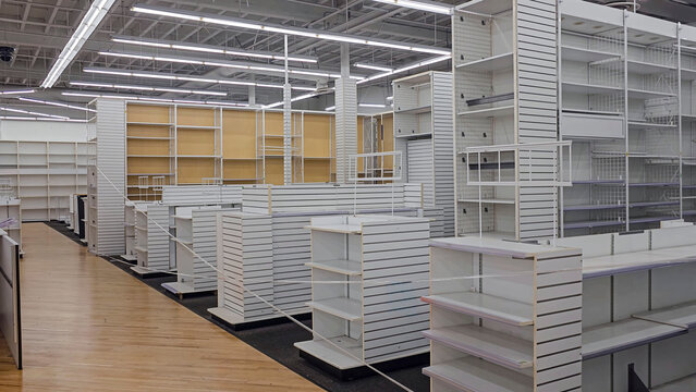 Empty retail store interior with white shelving