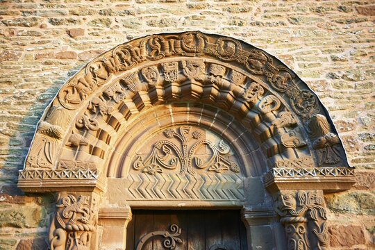 Norman Romanesque relief sculptures of dragons and mythical creatures, circa 1140, South doorway of Church of St Mary and St David, Kilpeck, Herefordshire, England, United Kingdom