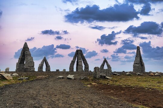 Gravel path to the Arctic Henge monument, large stone gates in a barren landscape, Heimskautsger&eth;i, Heimskautsgerdi, artist Erlingur Thorodsen, evening sky, Raufarh&ouml;fn, Melrakkasl&eacute;tta, North East Iceland, Iceland