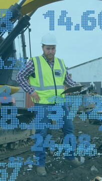 Vertical video: Foreman reading tablet lowering it showing blue numbers while inspecting scrap yard