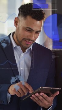 Vertical video: Man tapping tablet by window, creating business data overlays over torso for review