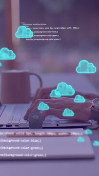 Vertical video: Hands typing on laptop, generating code and cloud icons drifting over keys for tech